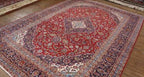 Decorative rug with intricate patterns on a wooden floor