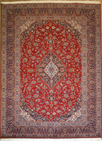 A traditional Kashan Persian rug with a central medallion design, featuring a red background with blue and beige floral motifs.